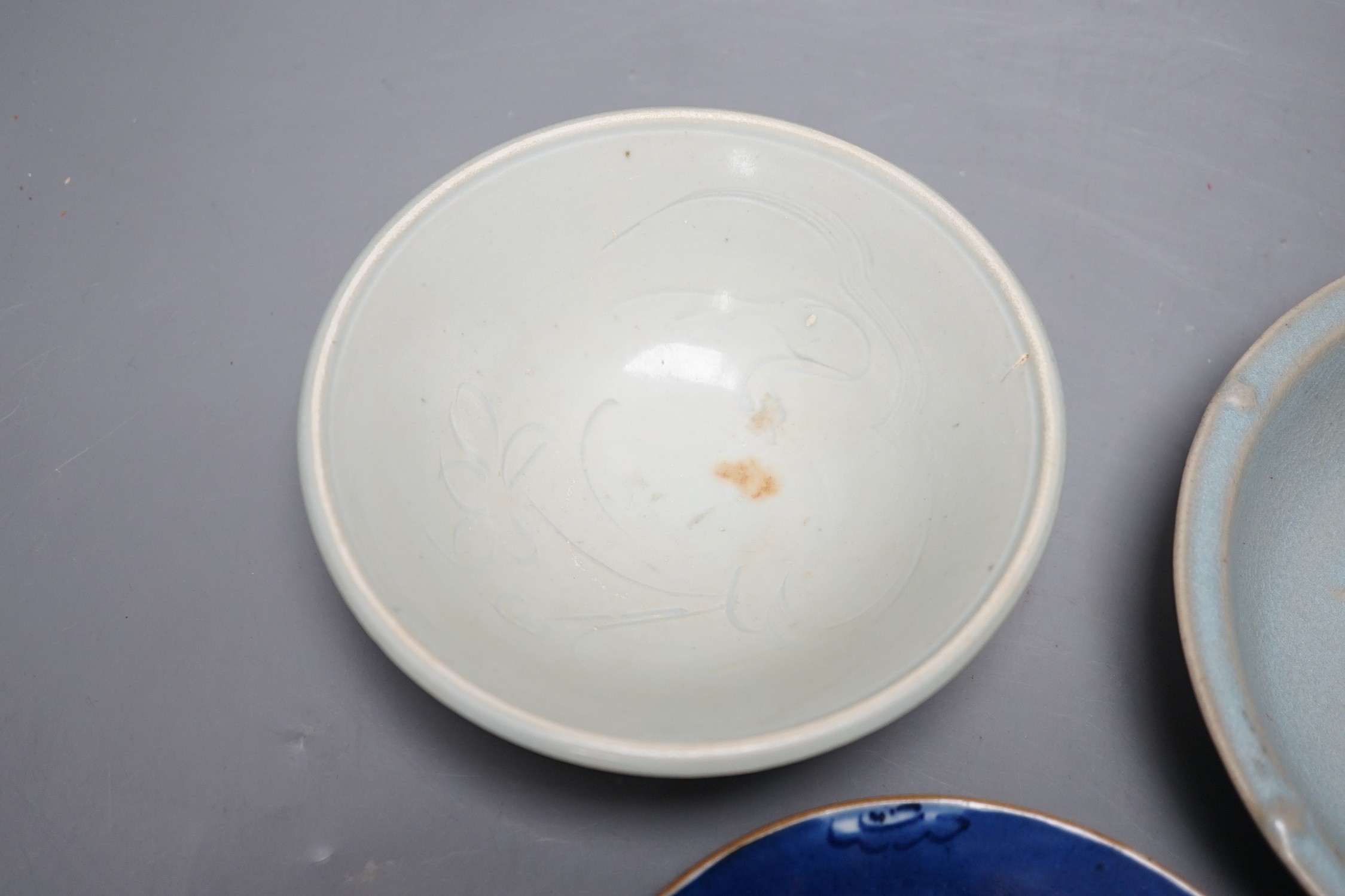 A group of three Chinese ceramics; a Qing Bai style bowl, a Jun style bowl with dragon relief decor and inscription to base, and a blue and white dish, tallest 6cm